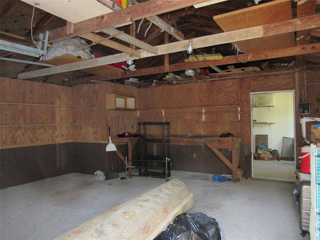Showing additional storage above the rafters in both front and back of garage.