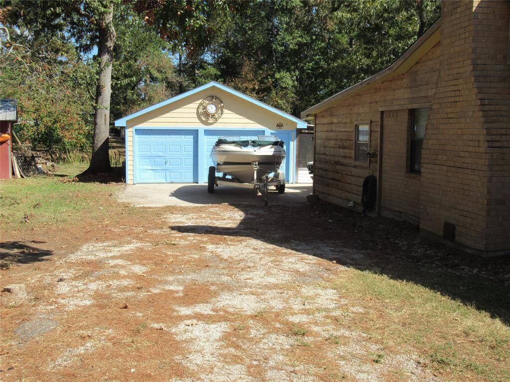 Showing 2 car garage with additional parking pad.