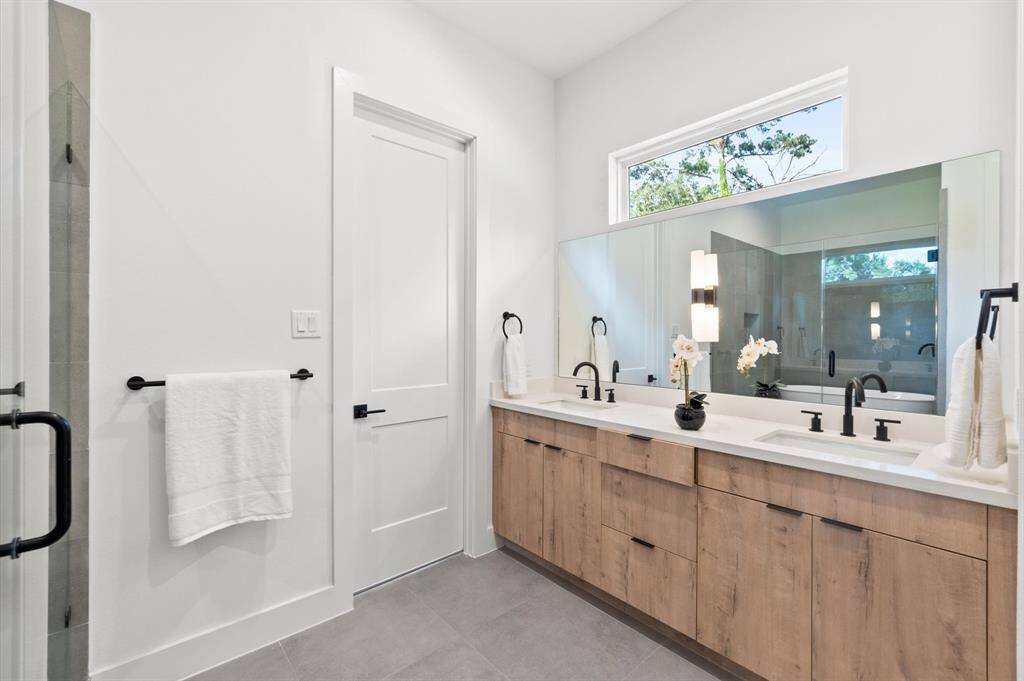 Primary bathroom containing a sleek wetroom.