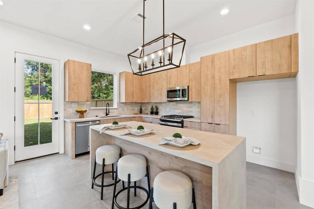 Custom built in cabinetry throughout the home, with a mudroom separating the kitchen and garage.