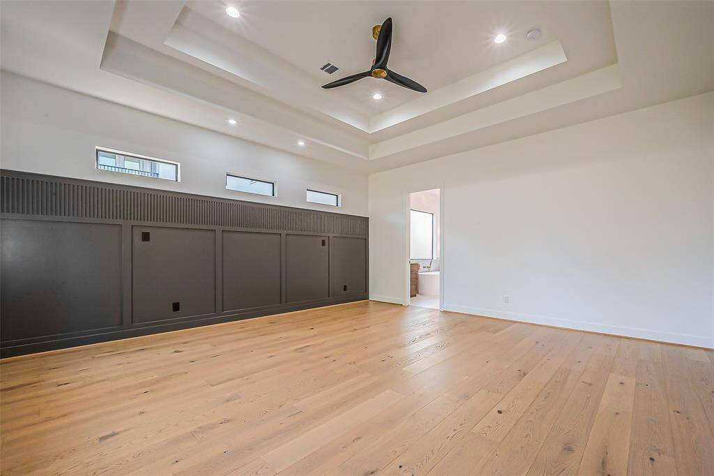 Primary bedroom with custom panel feature wall
