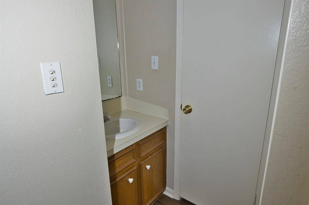 Hallway to the bedroom starts with the main bath