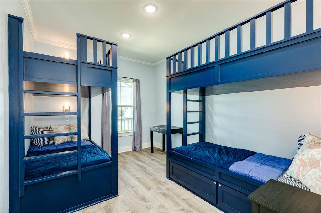 Secondary bedroom with built-in bunkbeds featuring under bed storage