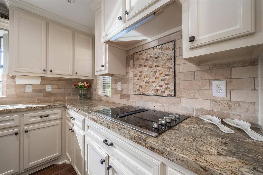 Beautiful stone backsplash and built-in cook top.
