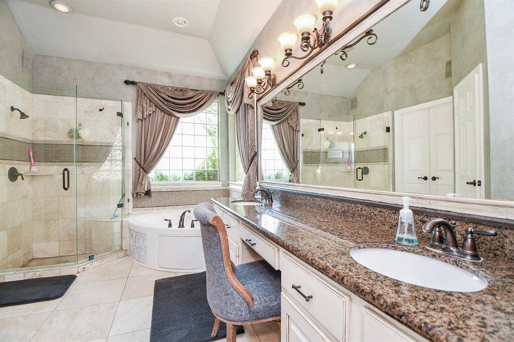There are no bounds when it comes to luxuriating in personal care and rhythms. Doing that in warm custom surroundings, in your primary ensuite bath, is the epitome of rich refinement; with dual sinks /vanity in creamy granite counters, with wall-wide framed mirror and classy lighting, above. The large rimless walk-in, glass enclosed shower sits right next to the cozy tub.