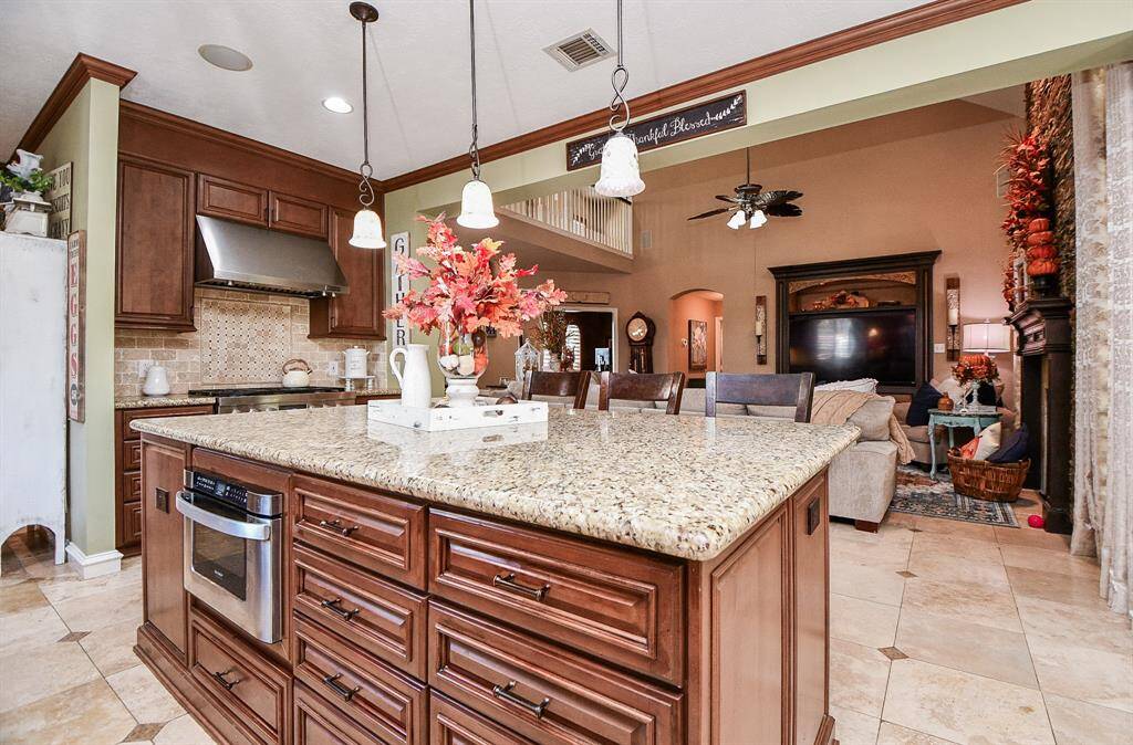 Cook and entertain to your heart's content and still be part of the fun with family and guests in the living area, ahead.