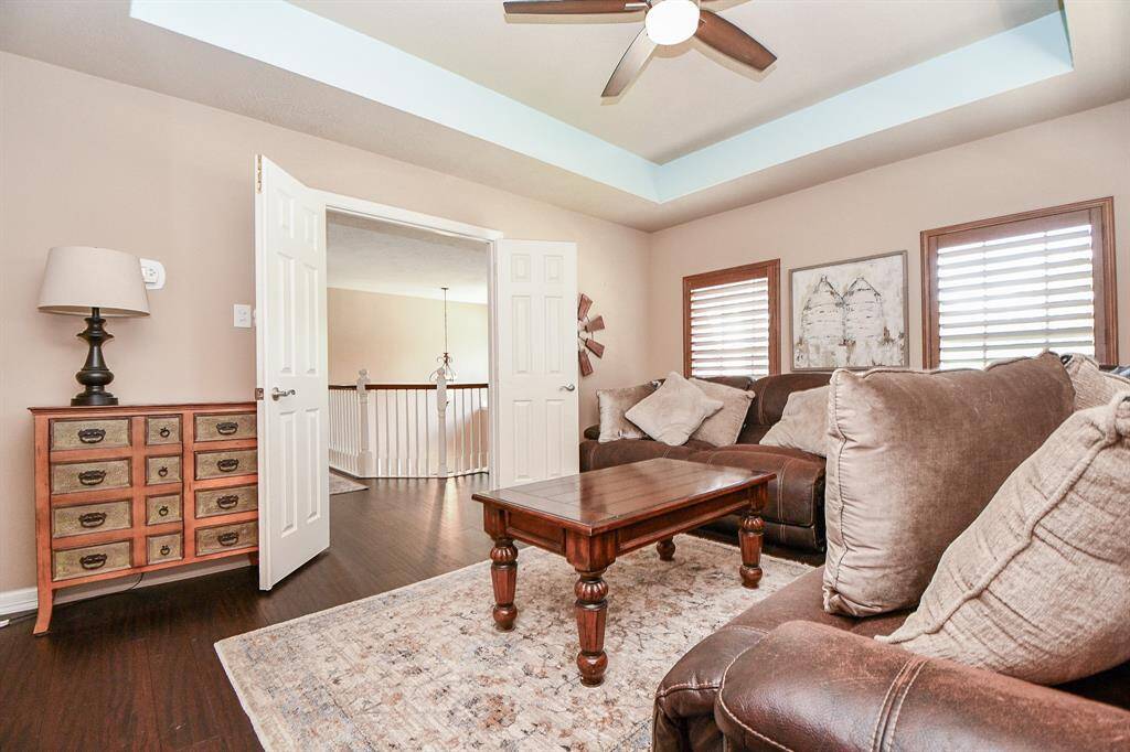 This casual den/living space hosts dual french doors, right off the staircase landing.