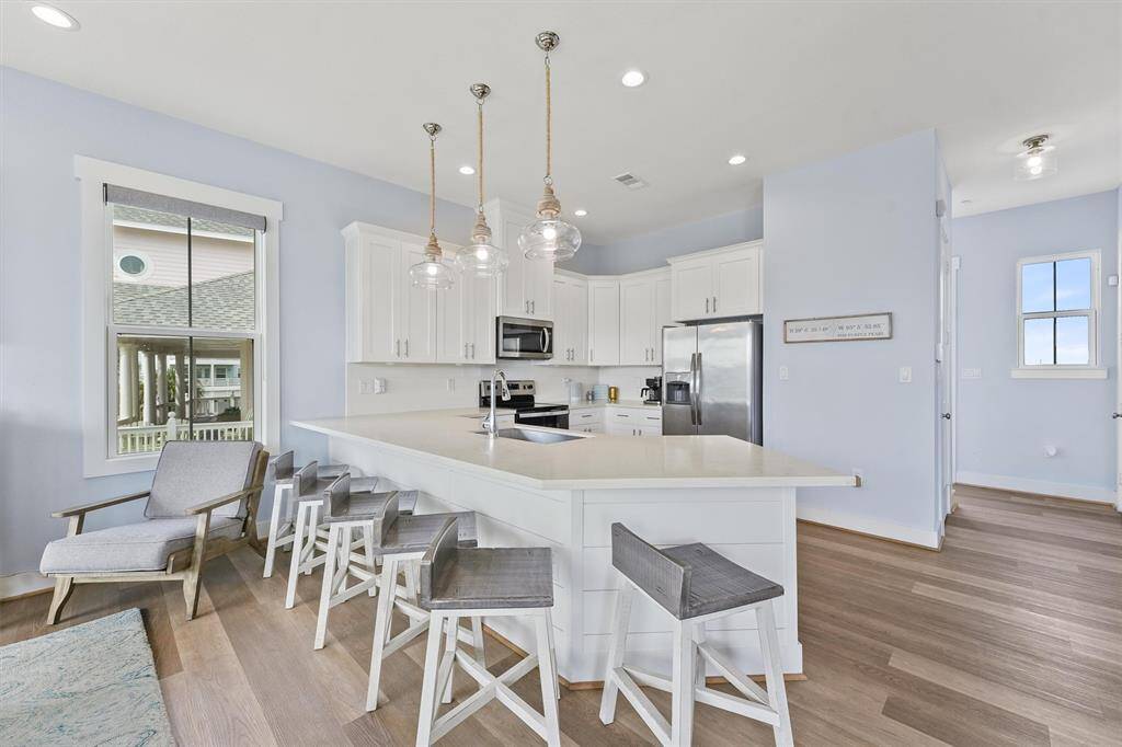 This open kitchen features aspacious island with seating forfour, perfect for casual dining orentertaining guests whilepreparing meals.