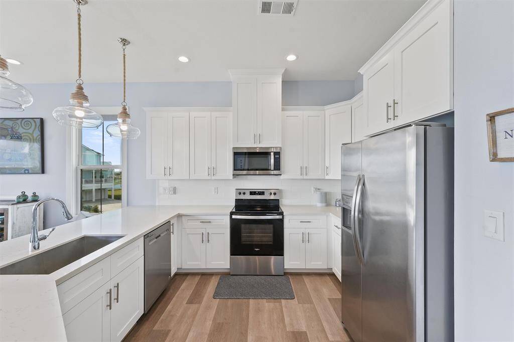 With sleek stainless steelappliances, quartz countertops,and crisp white cabinetry, thisfully equipped kitchen is a chef'sdream, offering style andfunctionality.
