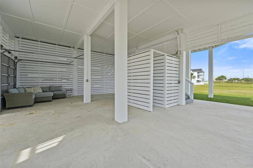 The expansive ground-levelpatio provides a perfect spacefor relaxation, with a cozyseating area and an outdoorshower for rinsing off after a dayat the beach.