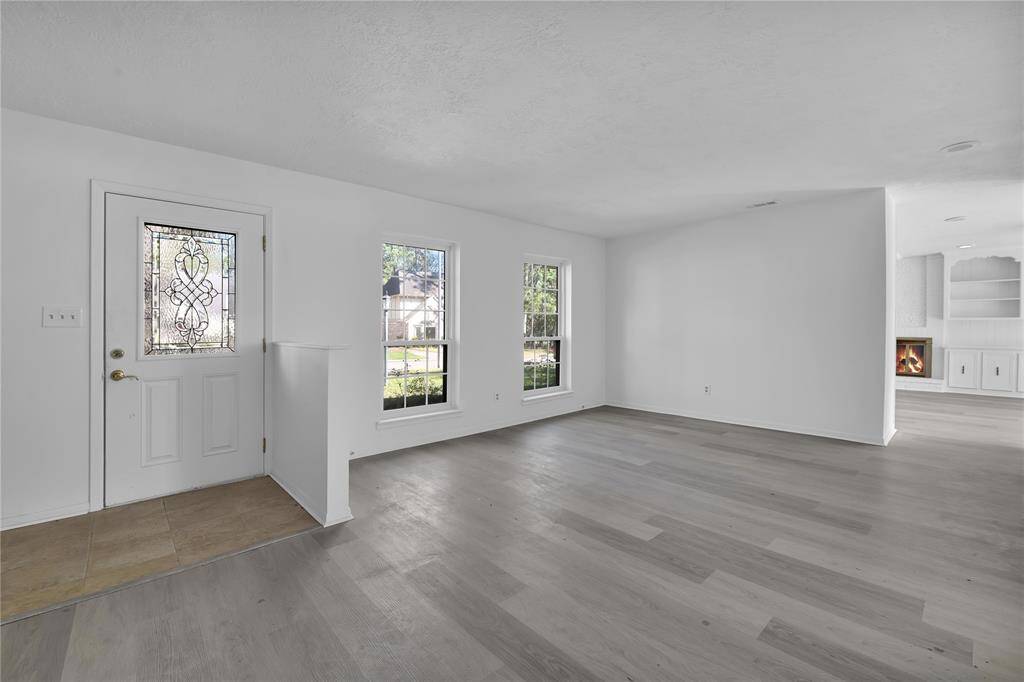 large living area... could have many uses... two living areas downstairs. Recent flooring!