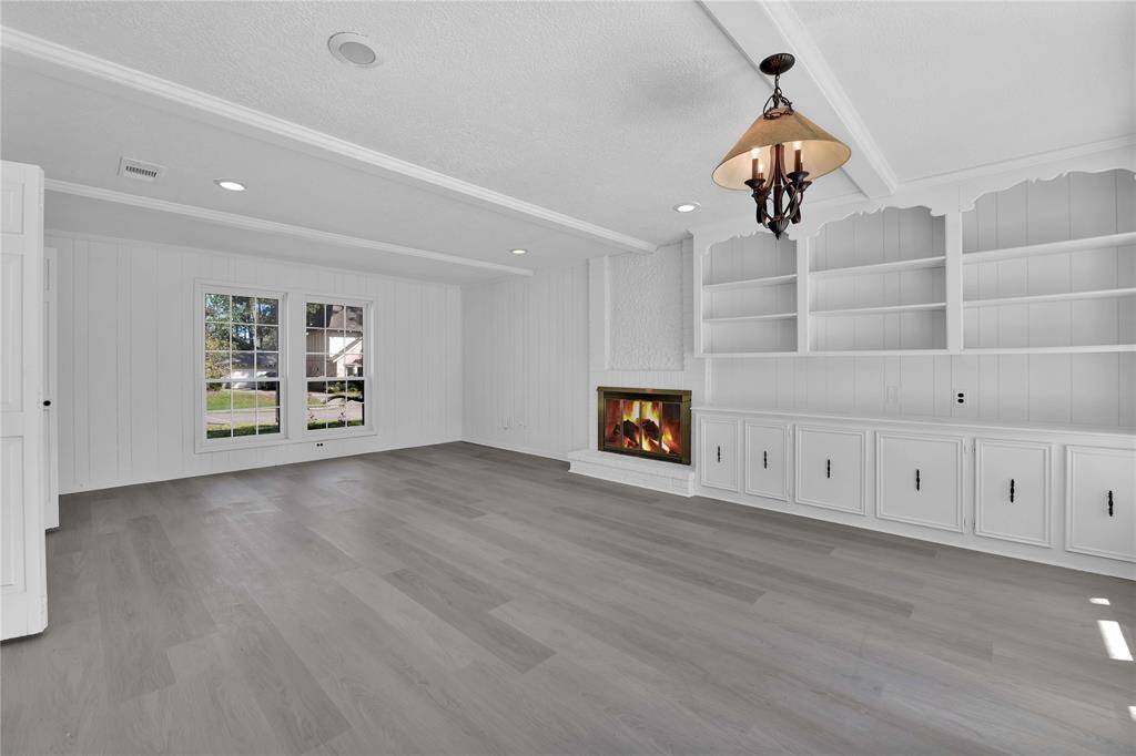 And... here we have the family room... with fireplace, built-in cabinetry and shelving, wet bar...