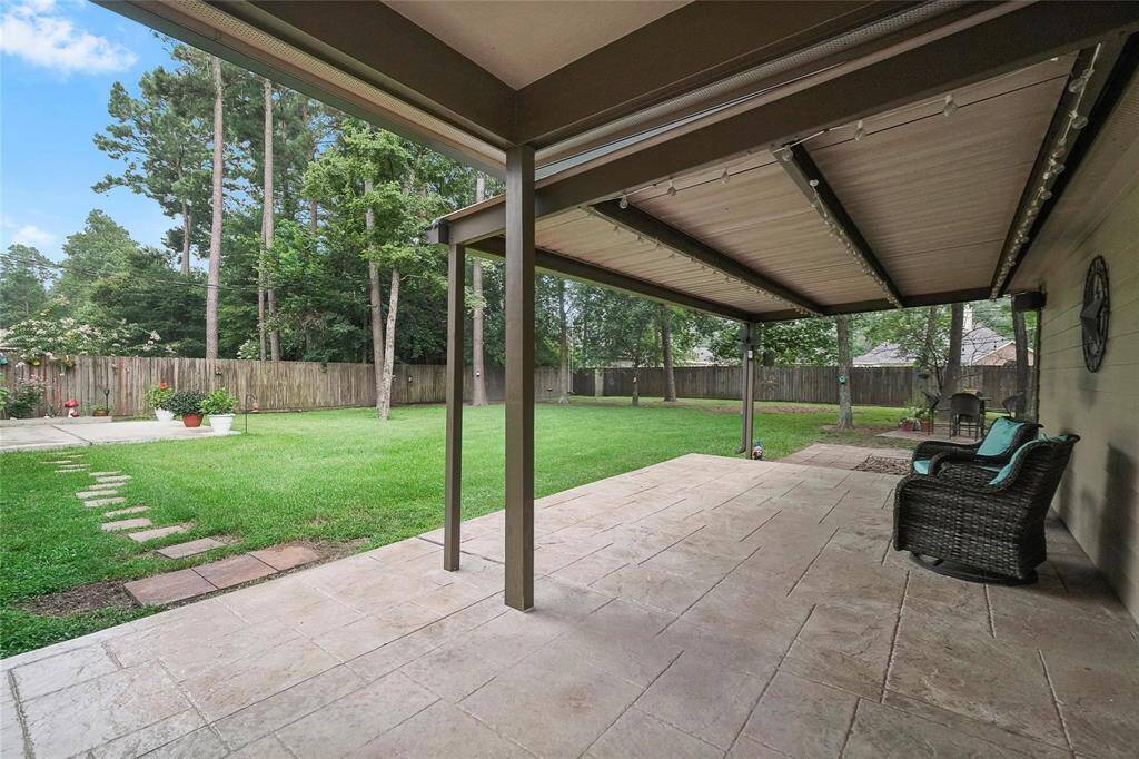Bach yard covered patio with outdoor lights, separate patio off Master Bedroom to the far left. Firepit area on right rear, shed unseen here
