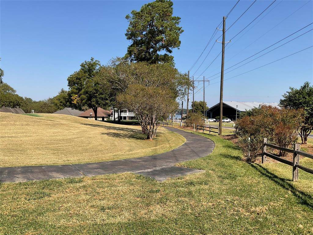 From the side yard you can see the lake just to the right of the tennis area.