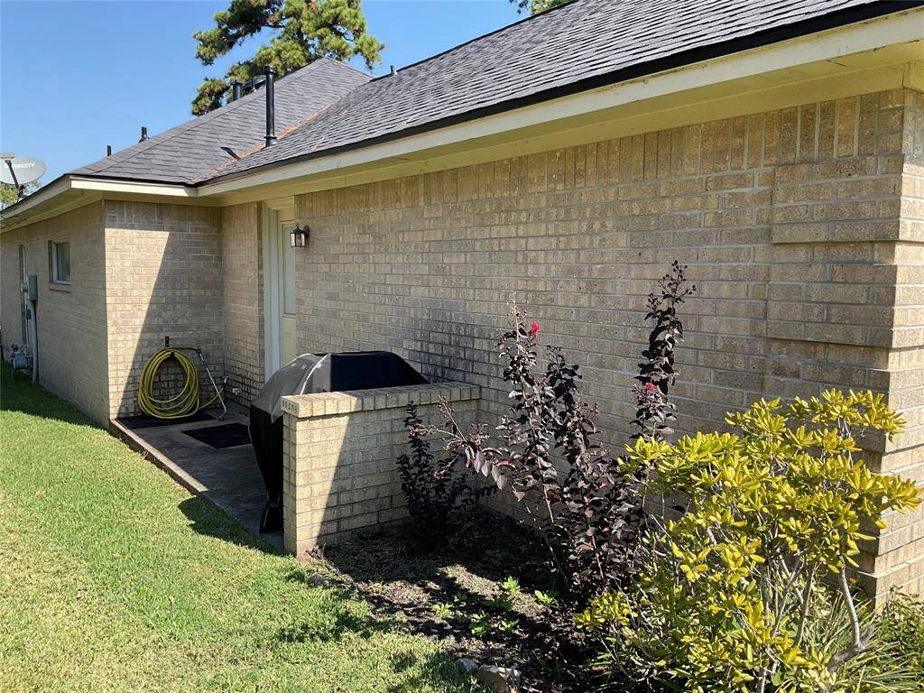 Left side of the house showing the exterior door into the garage.