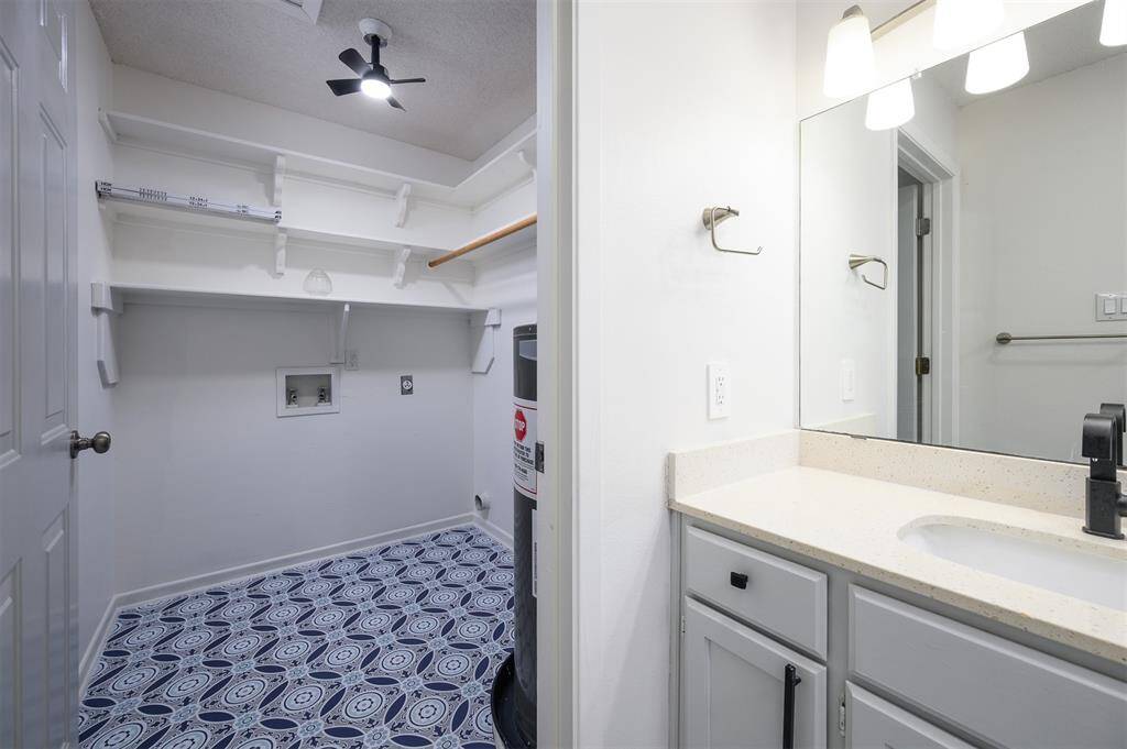 Laundry room for full size washer and dryer with hanging area