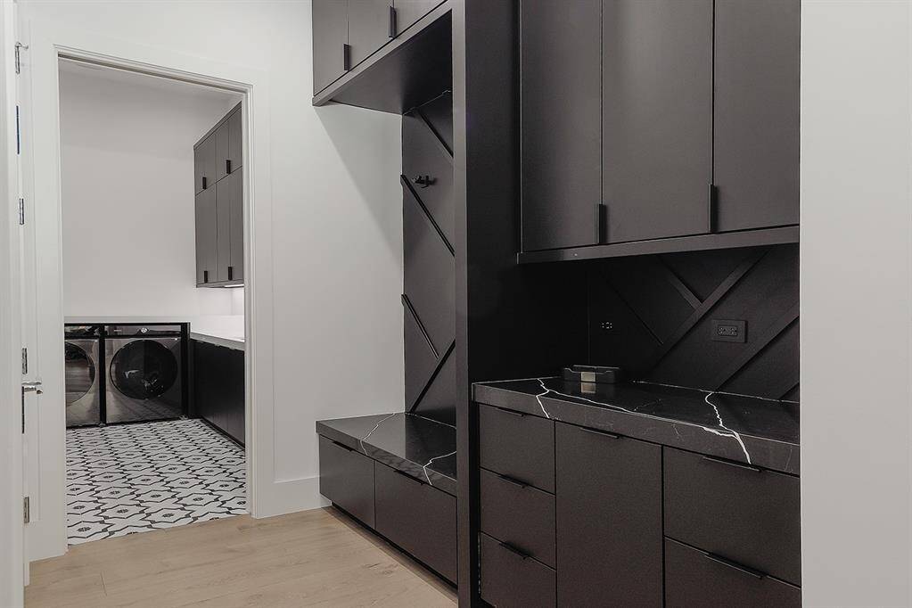 Mud room with ample storage leading to laundry room with washer/dryer and refrigerator included