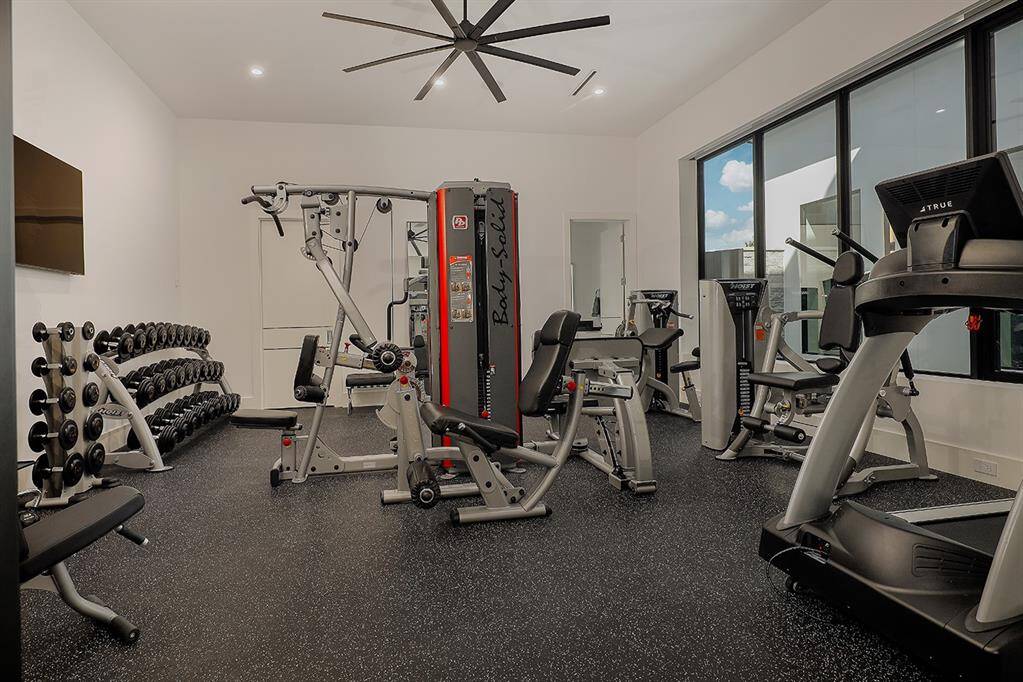 Second bedroom on first floor currently used as aprofessionally equipped gym.  Walk in closet and full bath.