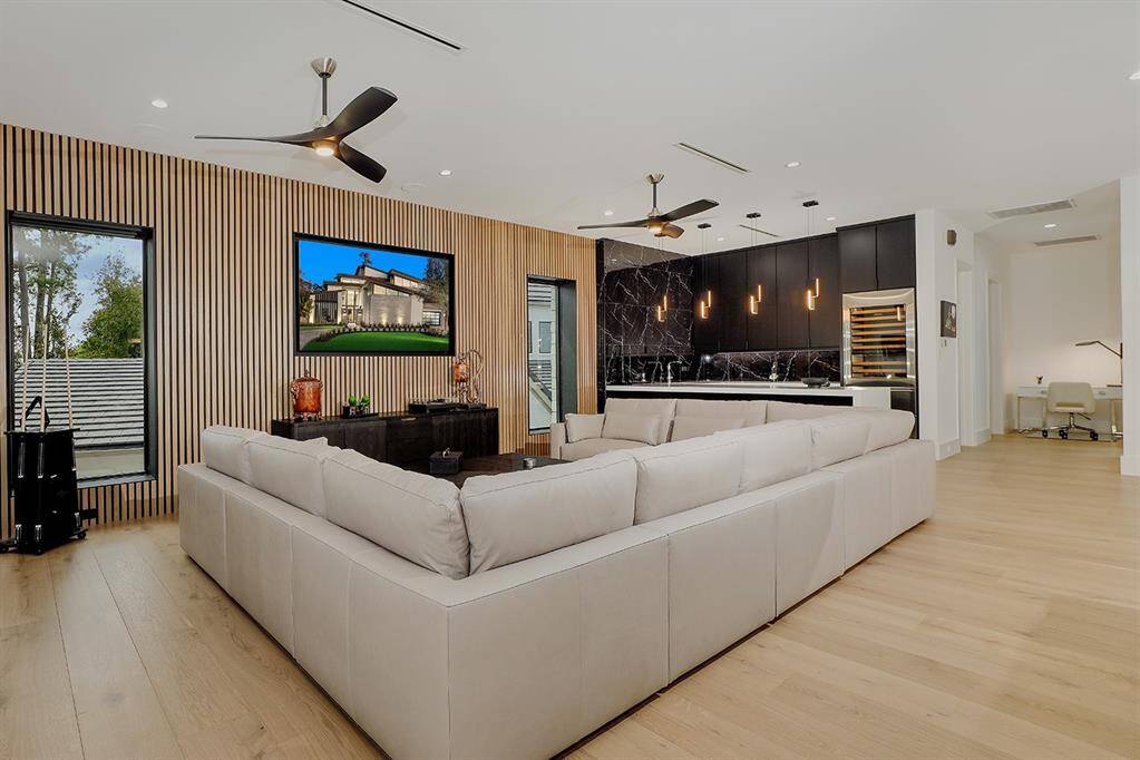 Open-concept living area with accent slatted wood walls.