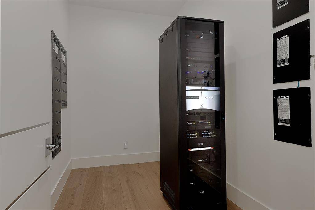 Dedicated air conditioned room for Smart Home from Creston & Lutron with Kaleidescape System ensuring easy access and management of the home's high technology.