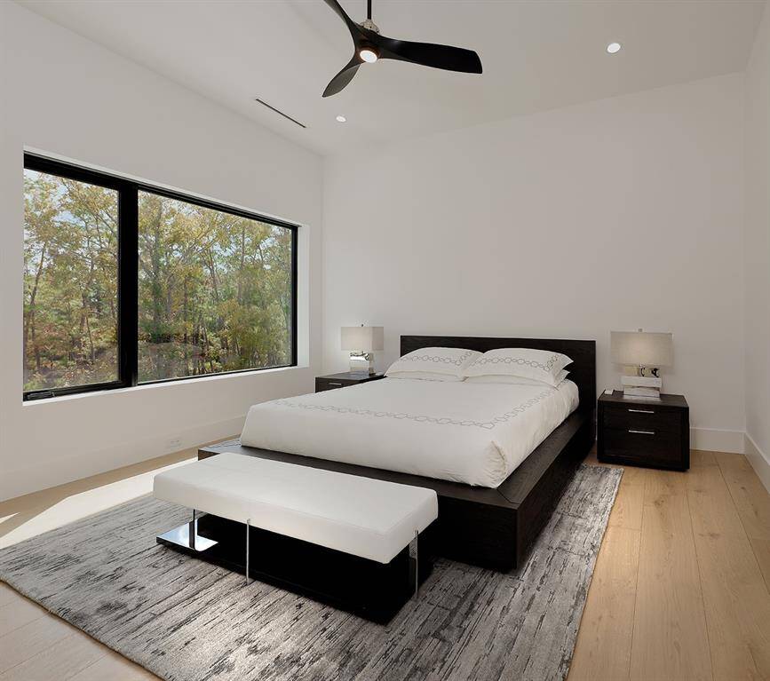 Second floor ensuite 3rd bedroom featuring a large window with a nature view.  Walk-in closet with built-in dresser.