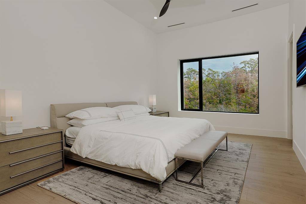 Spacious 4th bedroom and a sizeable window offering a view of natural greenery. Walk-in closet with built-in dresser.