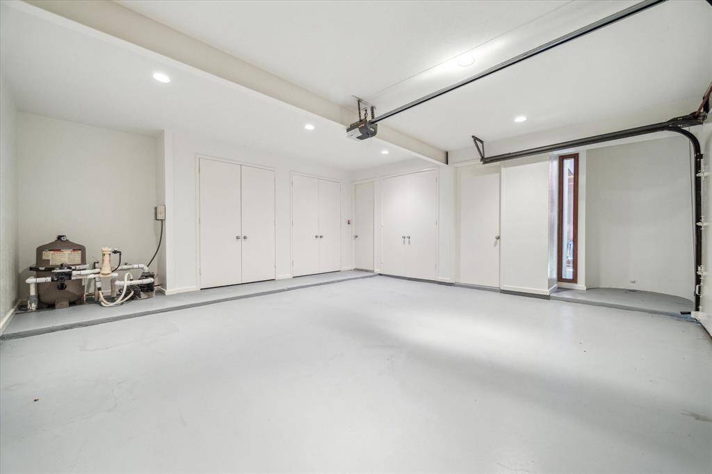 The recently painted two-car garage with lots of storage cabinets.