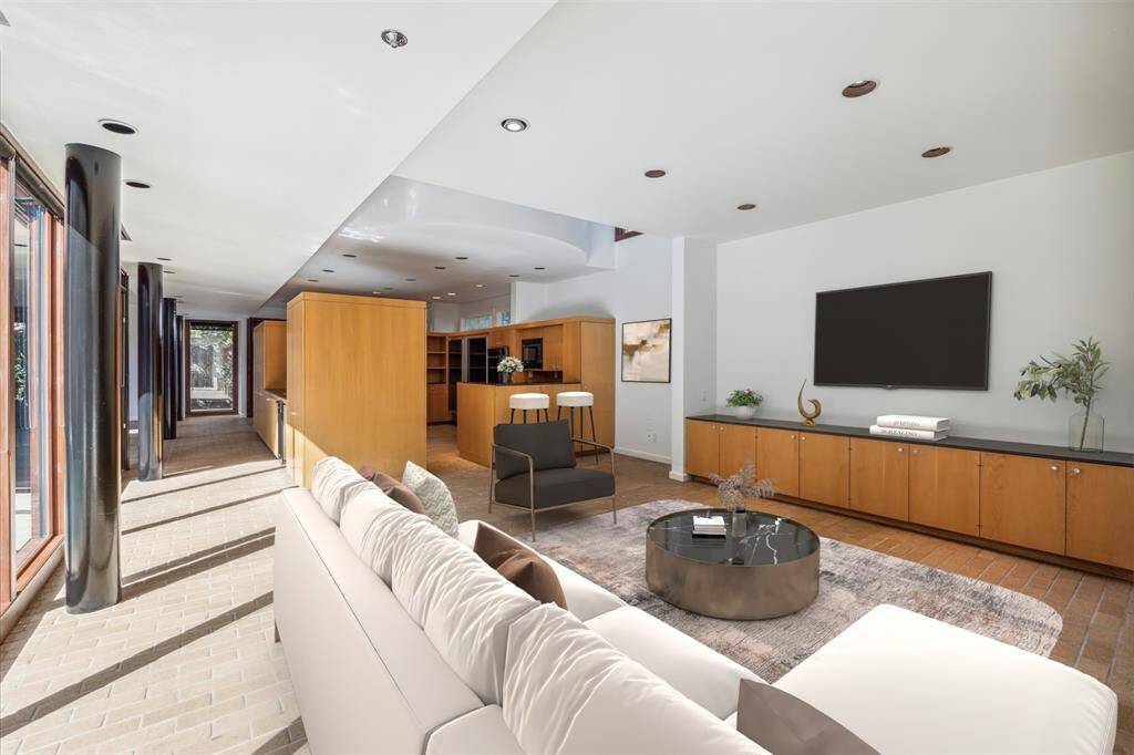 A view of the "floating kitchen" from the sitting room. Virtually staged.