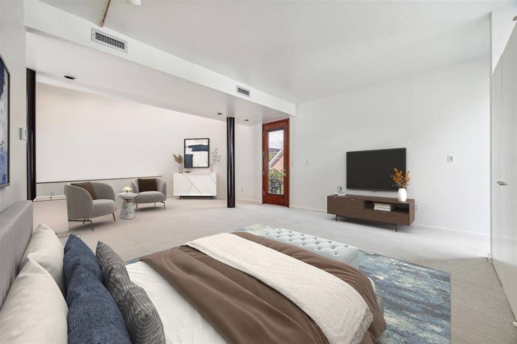 Primary bedroom with view of the  balcony wall. Virtually staged.