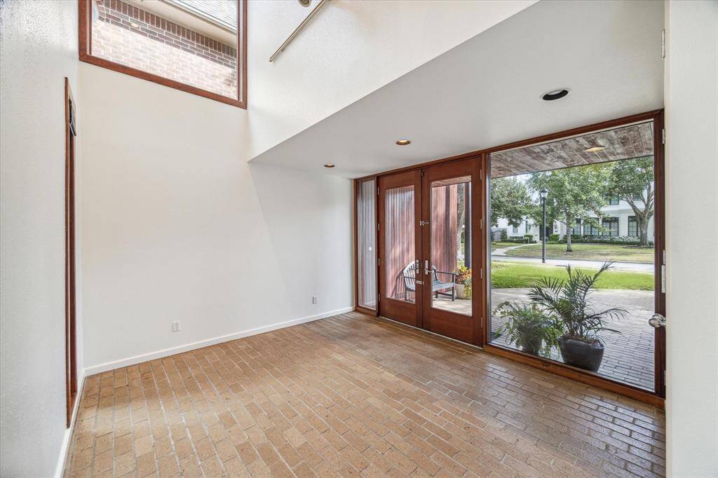 The entrancce to the home with brick flooring which is carried out through the entire first floor and pool decking.There are windows in strategic places throughout the home.