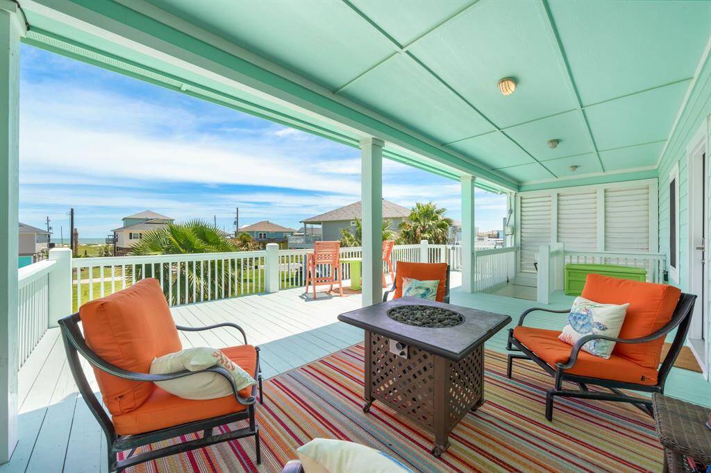 A cool and colorful spot to chill and you can peek the water view.  A Firepit table not pictured here is NEW!  Beyond this seating area you can see the covered stairs and a LIFT!