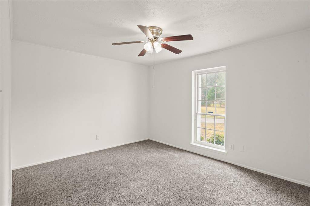 The front secondary bedroom is both spacious and inviting, offering a cozy retreat that balances comfort and functionality.