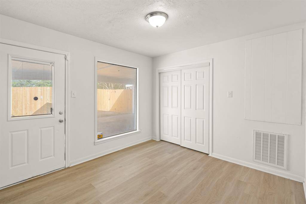 The breakfast room is ideal for a full-sized table and features easy care floors, fresh paint, a large bright window, overhead lighting and easy access to your backyard.