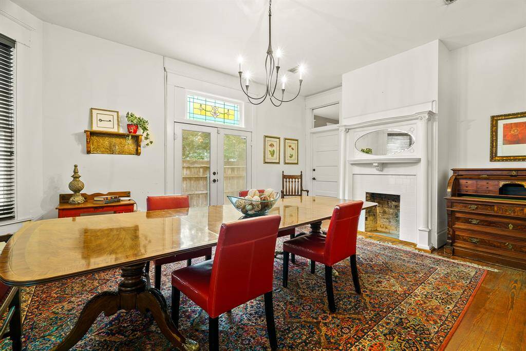 This dual-sided fireplace is outfitted with custom woodwork and oval mirror inlay that matches the front door. It is important to note that the closed door to the left of the fireplace leads directly into an Office, making it easy to pop over and grab additional material and quickly return to the meeting.