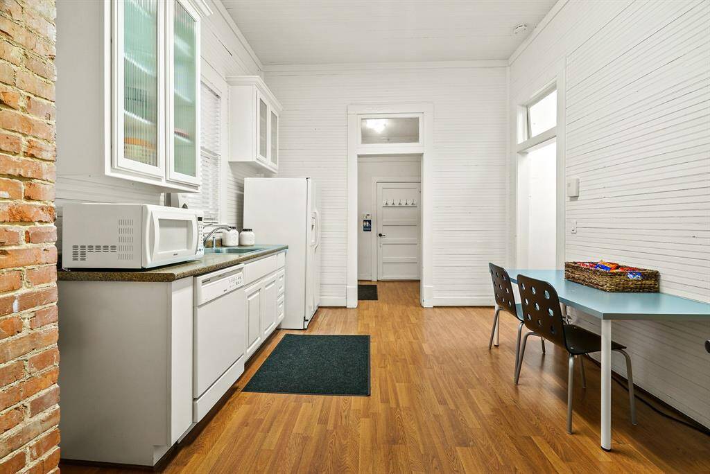 The Kitchen can easily house a small table and chairs. Through the cased opening straight ahead is the easily accessible Restroom with shower. Not pictured is the door that leads to the rear parking lot.