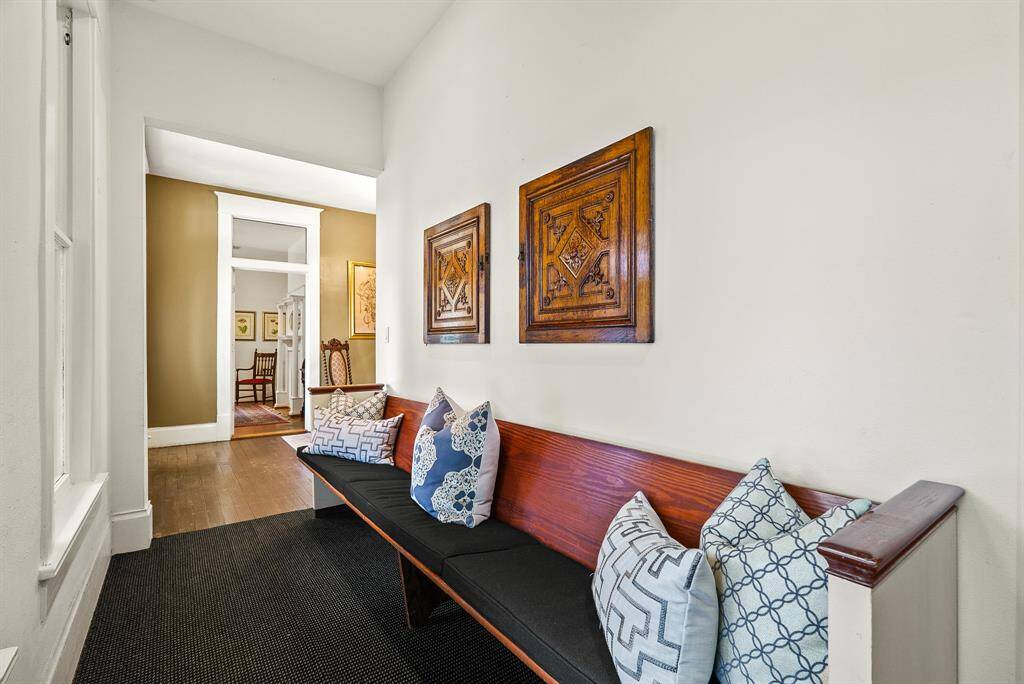 This hallway, located off the Foyer, leads to additional Offices and Conference Rooms. This space is light and bright thanks to the three large windows overlooking the large Front Porch.
