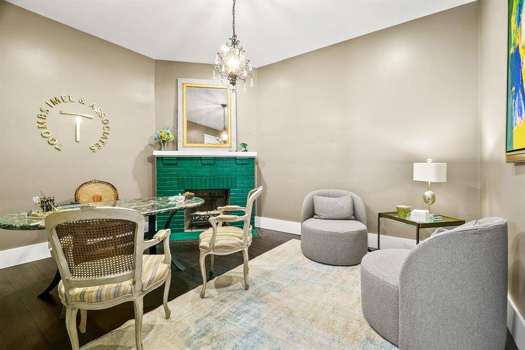 The original hard wood flooring continues into this stylish Office with extra-wide baseboards, lofty ceilings, and an antique chandelier.