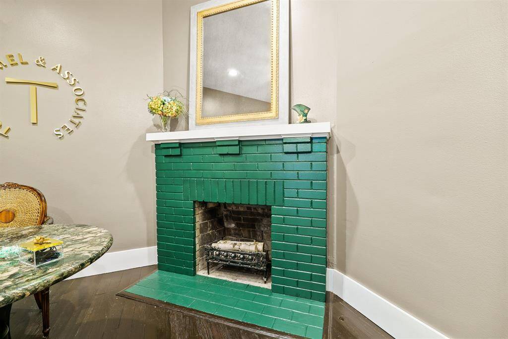 This wood burning fireplace is the focal point of the room thanks to this eye catching, green brick surround with solid wood mantle.  This feature really adds coziness to this Office.
