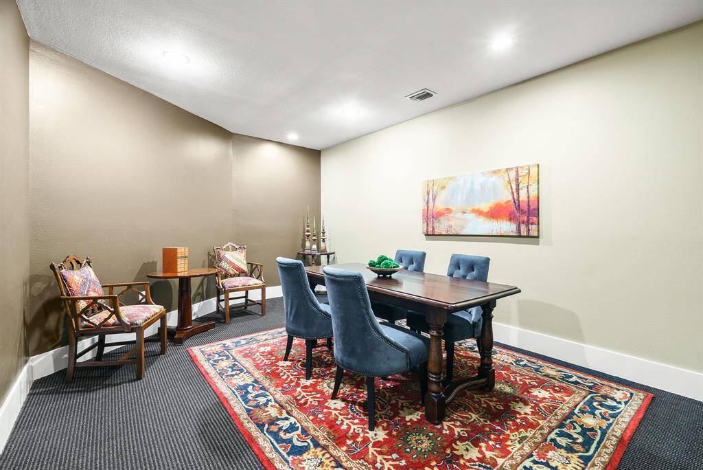 This two-toned Office boasts wall-to-wall carpeting, wide baseboards, and tall ceilings.