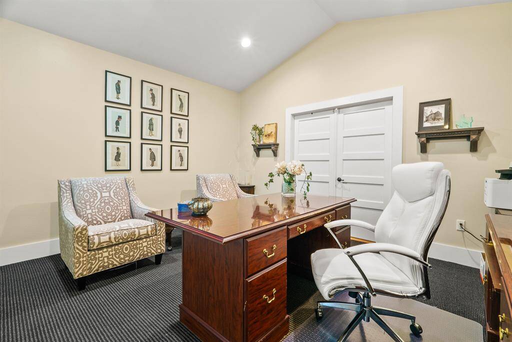 This impressive Office space features a cathedral ceiling, durable carpeting, and plenty of space to host a desk as well as additional seating. The double doors straight ahead opens into an impressively large storage hallway which leades to two additional storage spaces.