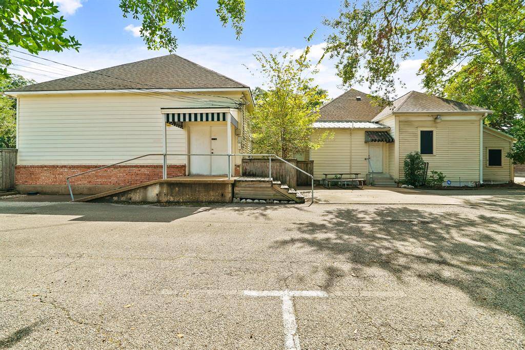 The property is reachable through two separate back doors. A concrete ramp leads to double doors directly to storage rooms while the single door leads into the Kitchen.
