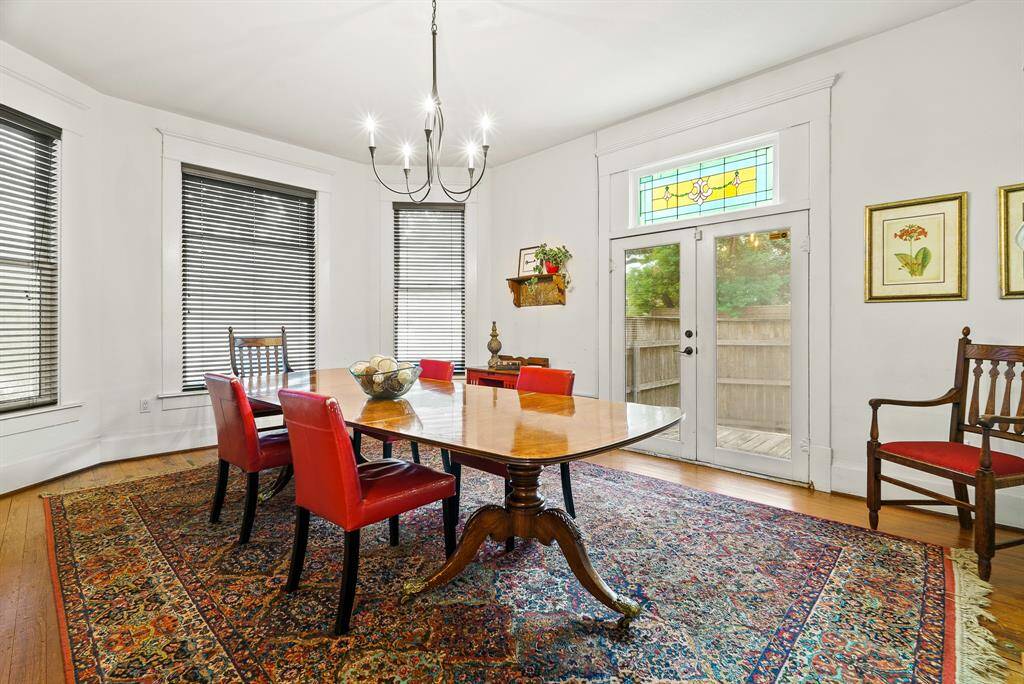 Located to the left, right off the Foyer, sits this spacious Conference Room and/or Office. The three front-facing windows welcome a healthy dose of sunlight. On a nice day, open the glass-plated French doors to invite in the fresh air and cool breeze of the outdoors. The stained-glass transom above is an antique and believed to be original to the home.
