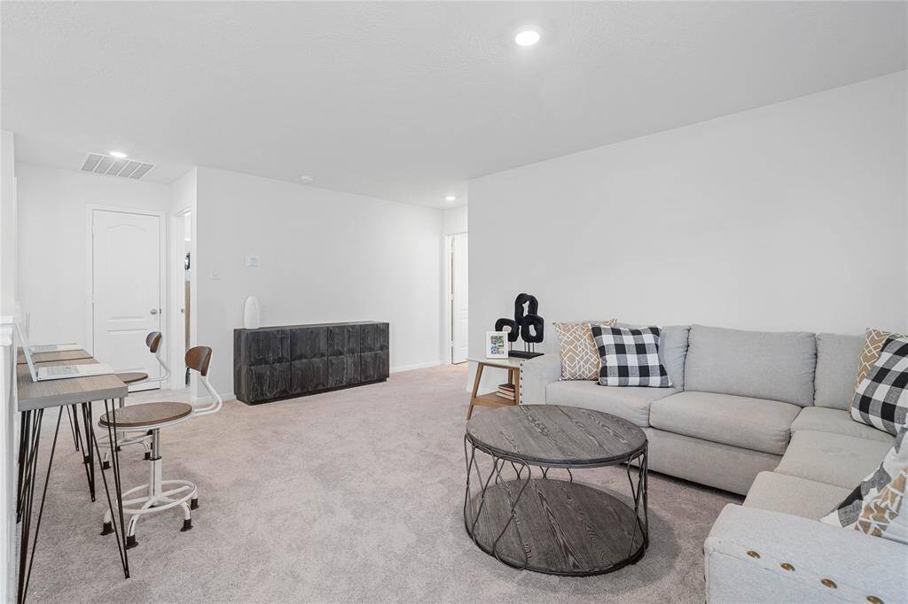 Come upstairs and enjoy a day of leisure in this fabulous loft! This is the perfect hangout spot or adult game room. This space features plush carpet, high ceiling, and custom paint