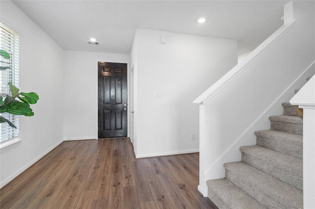 Welcome inside 18227 Sessile Oak where the spacious entryway is bright with recessed lighting, window, neutral paint and the beautiful vinyl plank flooring.
