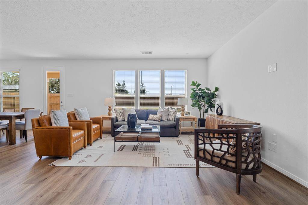 Gather the family and guests together in your lovely family room! Featuring high ceilings, custom paint, gorgeous vinyl plank flooring, and large windows with blinds that provide plenty of natural lighting throughout the day!
