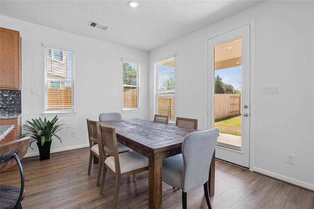 This lovely dining room is perfect for starting the day out on the right foot! This space showcases custom paint, high ceilings with recessed lighting, windows adding to the ample natural light in the kitchen, and vinyl plank flooring!