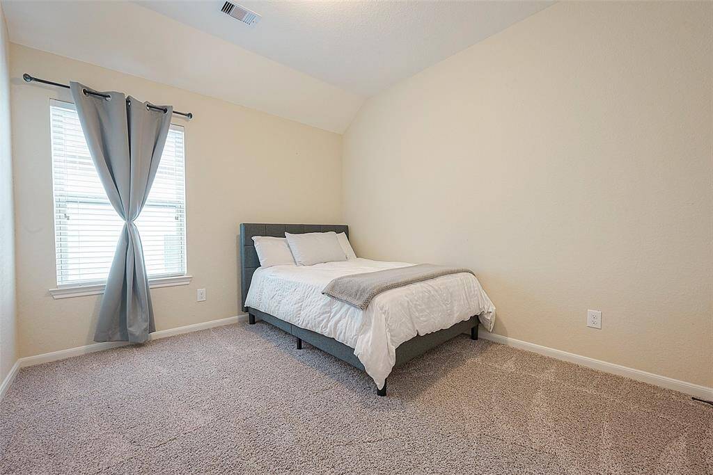 Cozy and bright, this inviting bedroom offers ample space and natural light—perfect for relaxation or a stylish guest retreat.