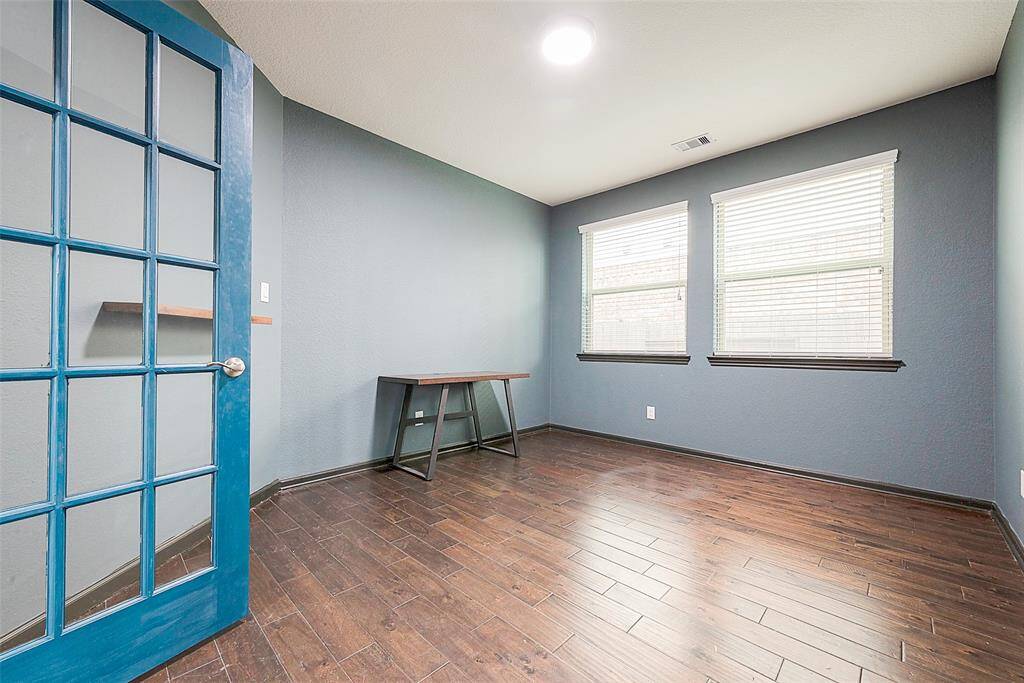 This versatile space, currently a study, can easily be transformed back into a formal dining room. It now features a fresh, neutral paint color.