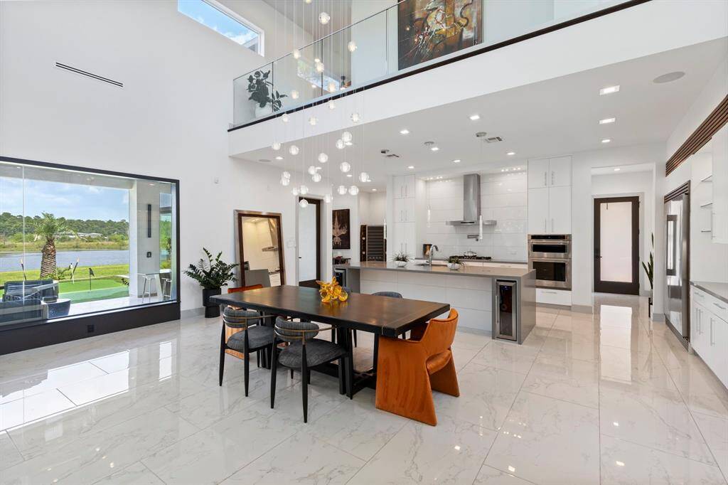 A fluid, open floor plan highlights rooms bathed in natural sun light and showcasing signature views.