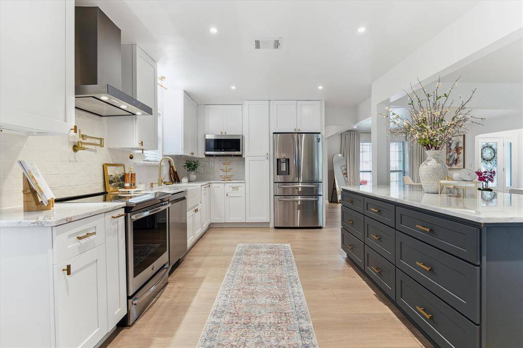 Alternate view of kitchen-pot filler, induction stovetop range, smart range hood with remote and bluetooth features